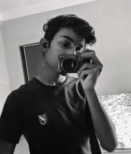 Sayan Paul taking a black-and-white mirror portrait with a camera
